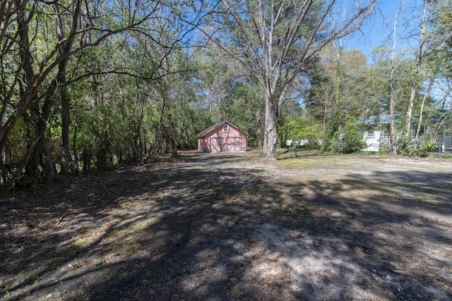 708 S Laurel St, Summerville, SC 29483 - view of yard with a barn, a forest view, an outdoor structure, and a detached garage