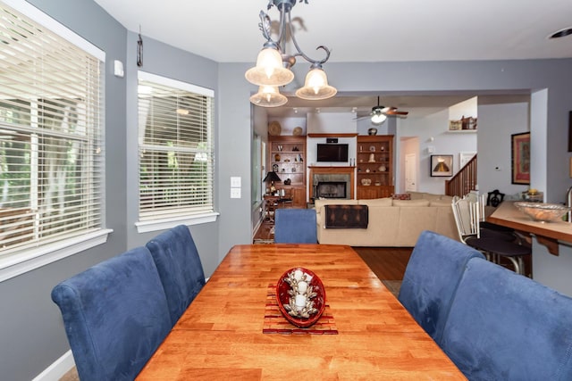 477 Commonwealth Rd, Mount Pleasant, SC 29466 - dining room featuring ceiling fan, wood finished floors, a tiled fireplace, and stairway