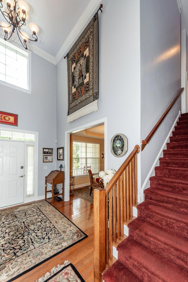 477 Commonwealth Rd, Mount Pleasant, SC 29466 - entrance foyer with a towering ceiling, a chandelier, stairs, healthy amount of natural light, and crown molding