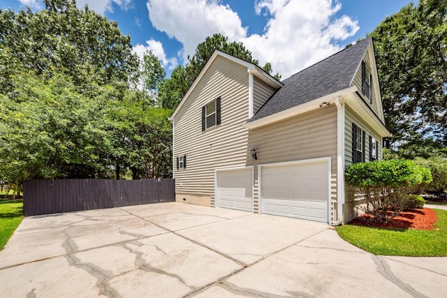 477 Commonwealth Rd, Mount Pleasant, SC 29466 - view of side of home with concrete driveway, a shingled roof, and a garage