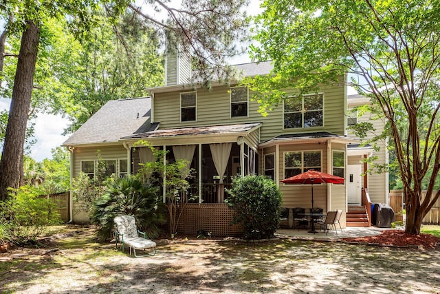 477 Commonwealth Rd, Mount Pleasant, SC 29466 - rear view of property featuring a chimney, entry steps, a patio area, roof with shingles, and a sunroom