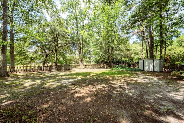 477 Commonwealth Rd, Mount Pleasant, SC 29466 - fenced backyard featuring a storage shed and view of wooded area