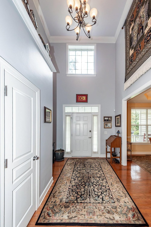 477 Commonwealth Rd, Mount Pleasant, SC 29466 - entryway with wood finished floors, a chandelier, healthy amount of natural light, crown molding, and a high ceiling