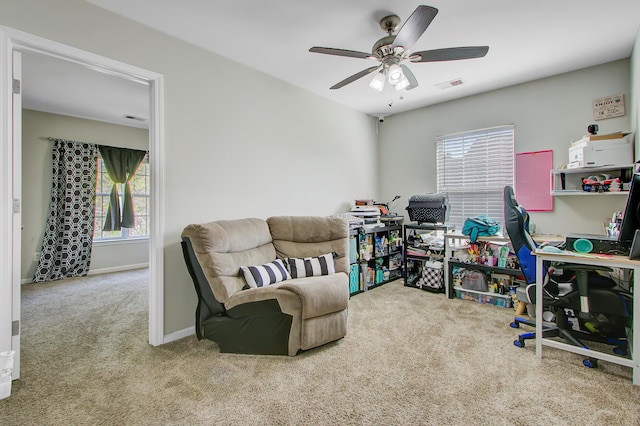 carpeted office space with visible vents, baseboards, and a ceiling fan