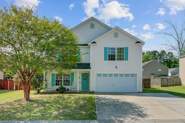 traditional-style home with a garage, a front yard, fence, and concrete driveway