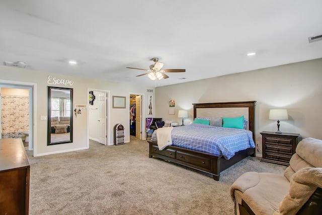bedroom with visible vents, baseboards, a spacious closet, a ceiling fan, and carpet floors