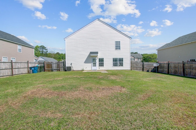 back of property featuring a yard and a fenced backyard