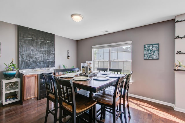 dining room featuring wine cooler, baseboards, dark wood-style floors, and visible vents
