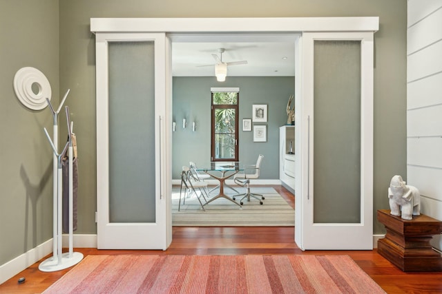 interior space with french doors, ceiling fan, and wood-type flooring