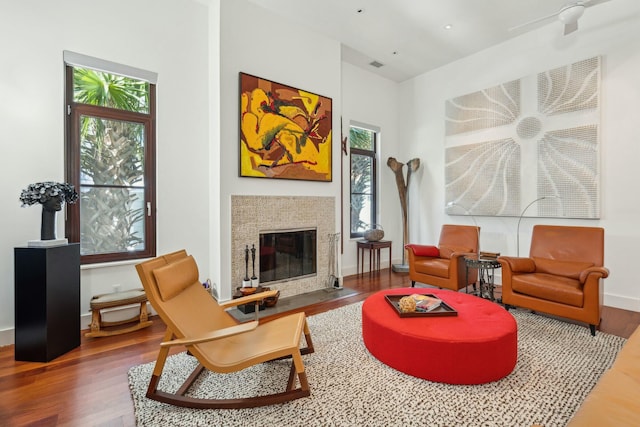 living area with plenty of natural light and dark hardwood / wood-style floors