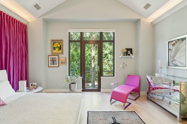 bedroom with hardwood / wood-style flooring and lofted ceiling