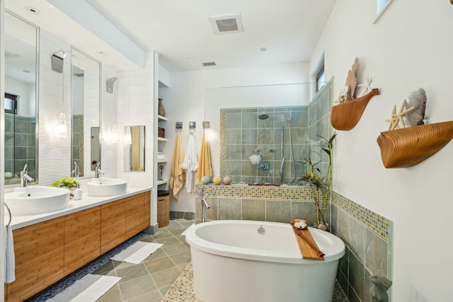 bathroom featuring vanity and separate shower and tub