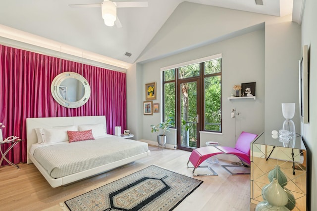 bedroom with ceiling fan, hardwood / wood-style floors, and lofted ceiling