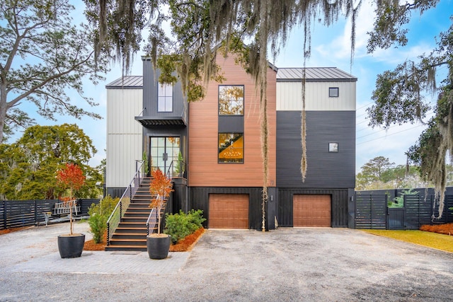 231 Bayview Dr, Mount Pleasant, SC 29464 - view of front of home featuring a standing seam roof, an attached garage, metal roof, stairs, and driveway