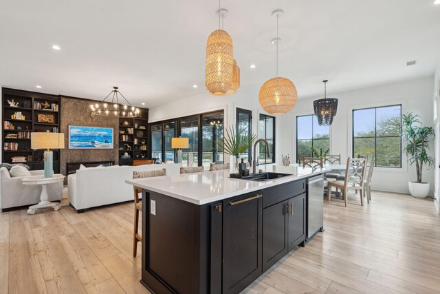 231 Bayview Dr, Mount Pleasant, SC 29464 - kitchen with a sink, a chandelier, stainless steel dishwasher, light countertops, and recessed lighting
