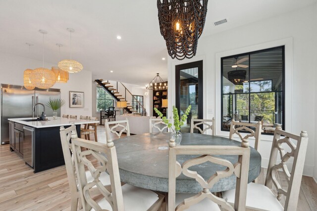 231 Bayview Dr, Mount Pleasant, SC 29464 - dining area featuring a chandelier, light wood-style floors, stairway, and recessed lighting