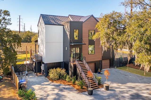 231 Bayview Dr, Mount Pleasant, SC 29464 - contemporary house featuring stairs, a garage, and asphalt driveway