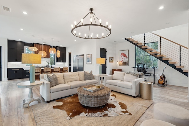 231 Bayview Dr, Mount Pleasant, SC 29464 - living room featuring a chandelier, light wood-style flooring, recessed lighting, and stairs