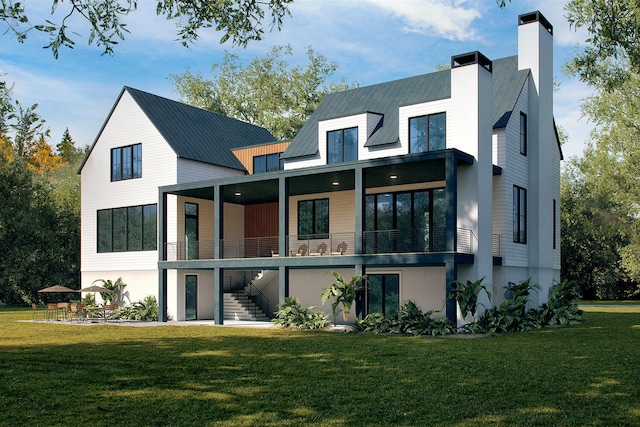 rear view of house featuring a yard and a balcony