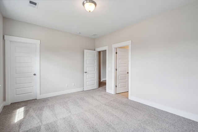 unfurnished bedroom with light colored carpet