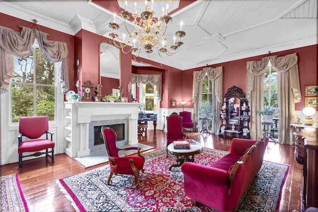 sitting room featuring wood-type flooring, a fireplace with flush hearth, a wealth of natural light, and crown molding