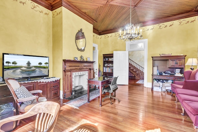 living room featuring wooden ceiling, ornamental molding, light wood-style floors, a fireplace, and a notable chandelier