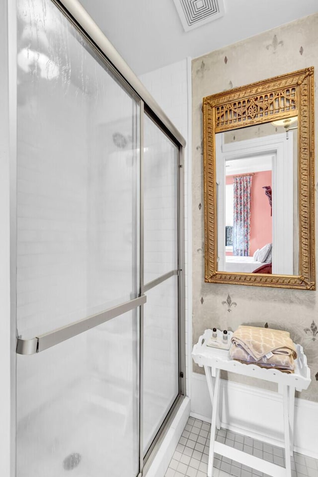 ensuite bathroom featuring ensuite bathroom, a shower stall, visible vents, and tile patterned floors