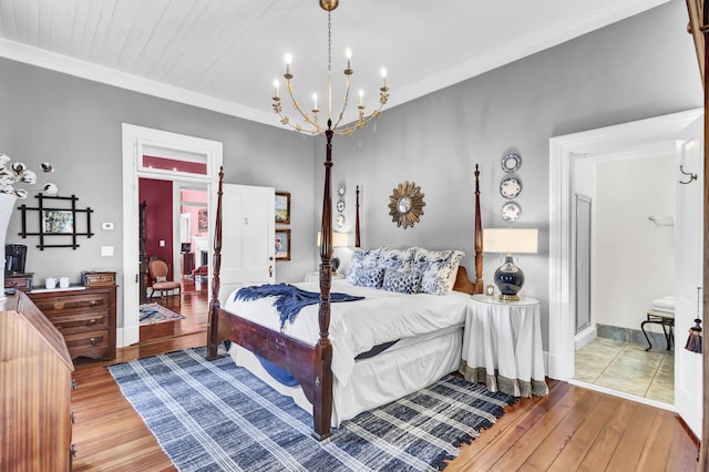 bedroom featuring baseboards, crown molding, a chandelier, and hardwood / wood-style floors