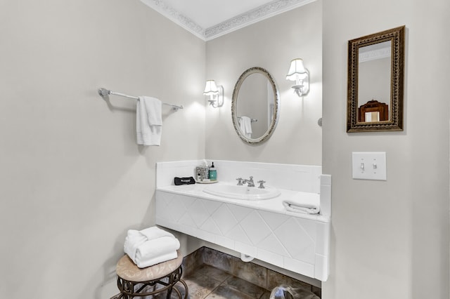 bathroom featuring ornamental molding and a sink