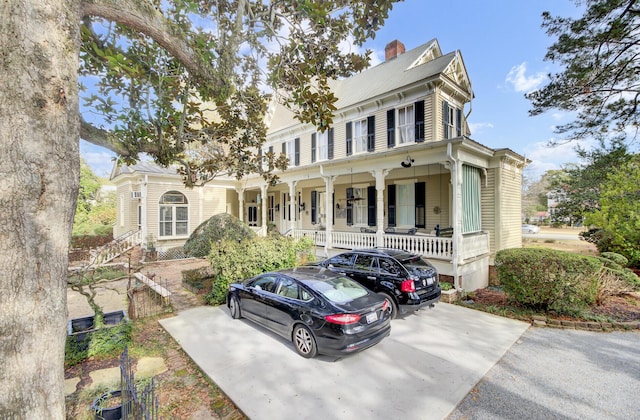 view of front of home featuring a porch and a chimney