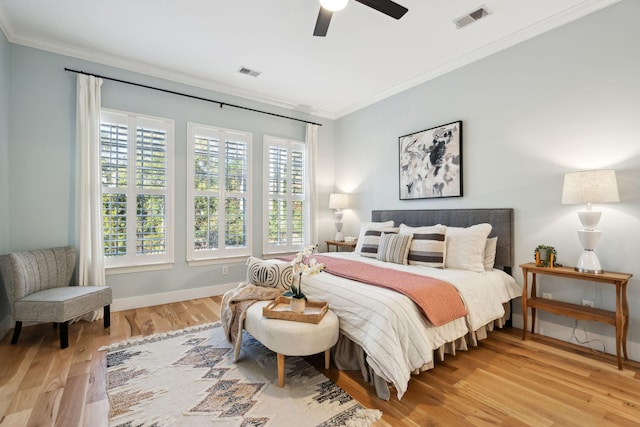 bedroom featuring ceiling fan, ornamental molding, and light hardwood / wood-style floors