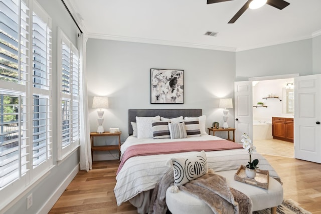 bedroom with connected bathroom, ornamental molding, ceiling fan, light hardwood / wood-style floors, and multiple windows