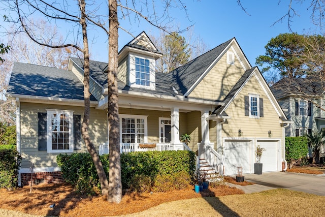 new england style home featuring a garage and covered porch