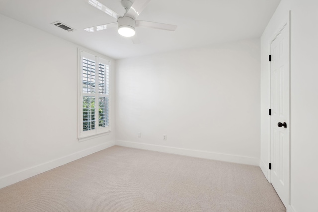 unfurnished room with ceiling fan and light carpet