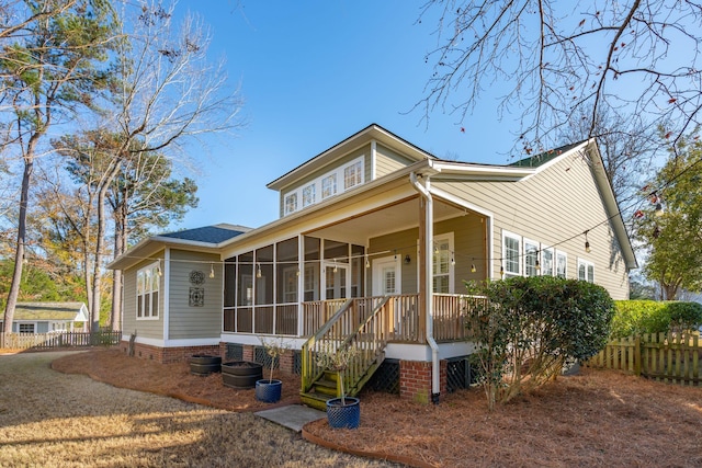 view of front of home featuring a sunroom