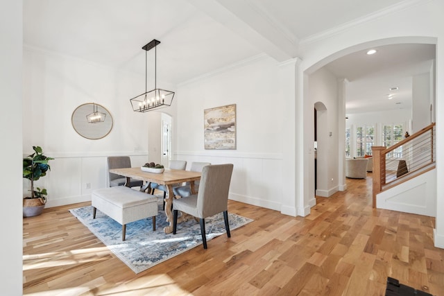 dining room with ornamental molding and light hardwood / wood-style floors