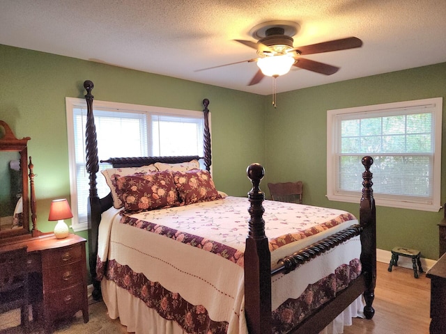 1216 Eastwood Ave, Hanahan, SC 29410 - bedroom with light wood-type flooring, a ceiling fan, a textured ceiling, and baseboards