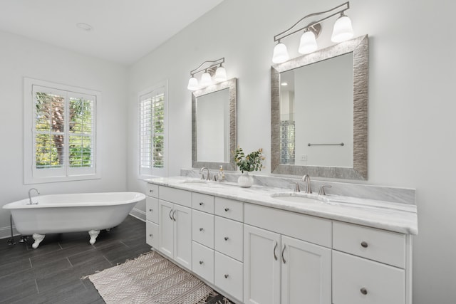 591 Island Walk E, Mount Pleasant, SC 29464 - bathroom featuring double vanity, a freestanding bath, and wood finish floors