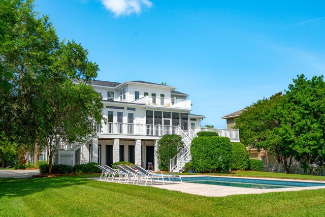 591 Island Walk E, Mount Pleasant, SC 29464 - rear view of house featuring stairs, a sunroom, a balcony, and an outdoor pool