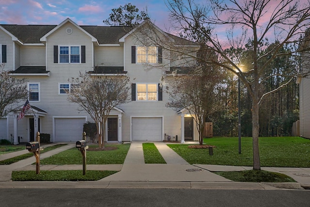 view of front of home featuring a garage and a yard