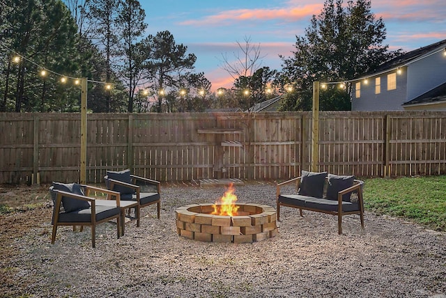 patio terrace at dusk featuring a fire pit