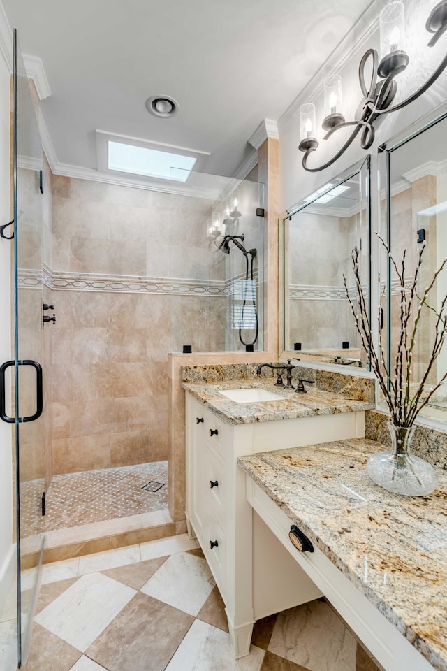 full bathroom with a stall shower, crown molding, vanity, and a skylight