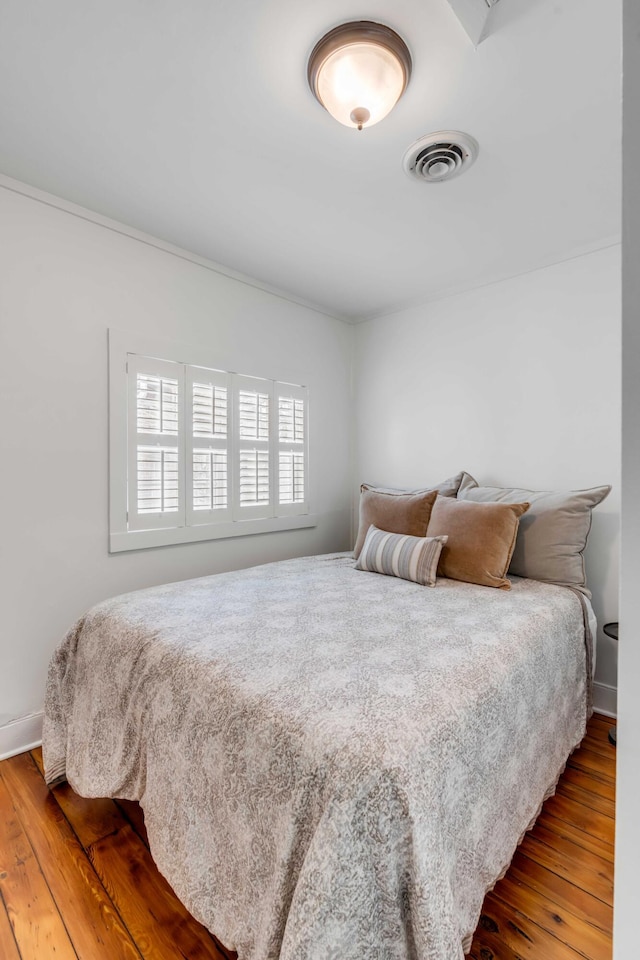 bedroom with wood finished floors and visible vents