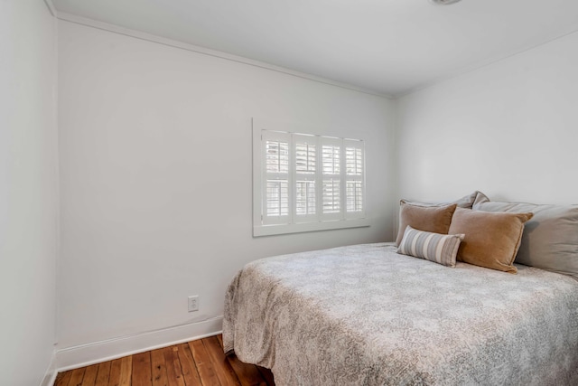 bedroom with baseboards and wood finished floors