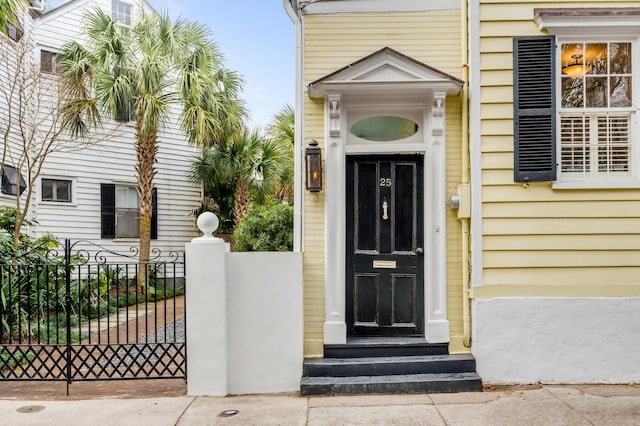 doorway to property featuring fence and a gate