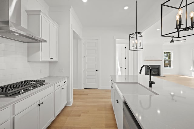 71 Downing Dr, Beaufort, SC 29907 - kitchen featuring wall chimney exhaust hood, a sink, appliances with stainless steel finishes, light wood-style floors, and recessed lighting
