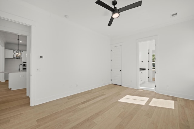 71 Downing Dr, Beaufort, SC 29907 - spare room with light wood-style flooring, a ceiling fan, baseboards, and crown molding