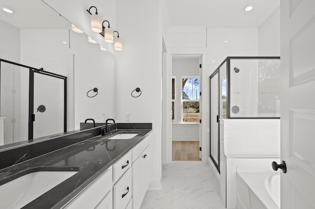 71 Downing Dr, Beaufort, SC 29907 - bathroom featuring marble finish floors, a stall shower, recessed lighting, a garden tub, and double vanity