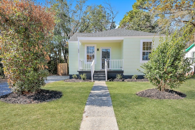 bungalow-style home with a front yard