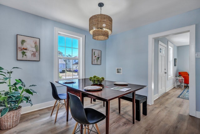 dining area featuring hardwood / wood-style flooring and a chandelier